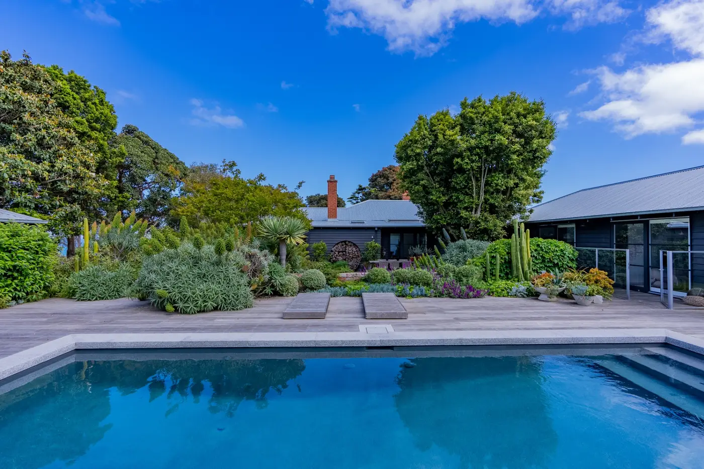 Bloomberry landscaped garden with pool, deck and lush planting on the Mornington Peninsula